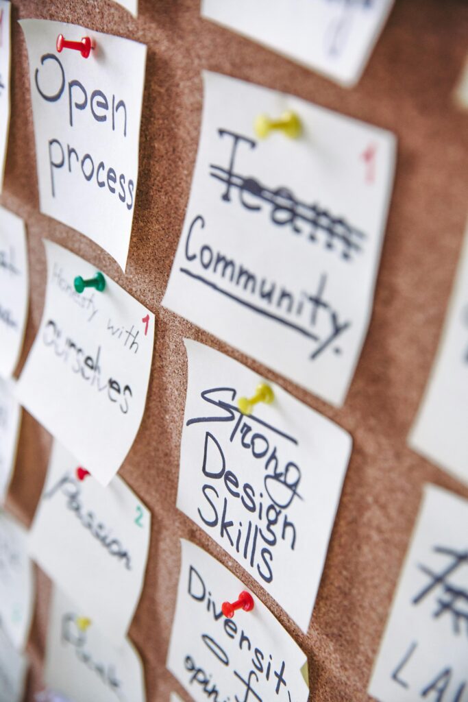 pexels-photo-3782226-3782226 Pinned notes on a corkboard showcasing team collaboration and design skills.
